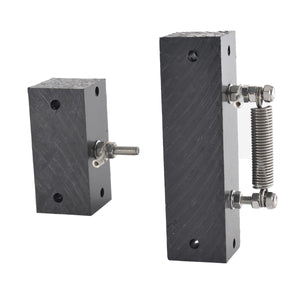 Two dark gray cast iron mounting blocks with threaded steel bolts and a coiled steel spring, shown on a plain white background.