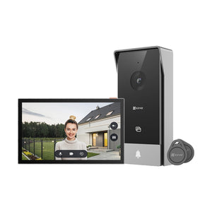 The image shows a video intercom kit which includes a black indoor monitor with a screen displaying an image of a woman at the door, and a black outdoor doorbell with a camera and button.